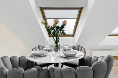 a dining room with a table and chairs at Kaunas Old Town apartment with underground parking in Kaunas