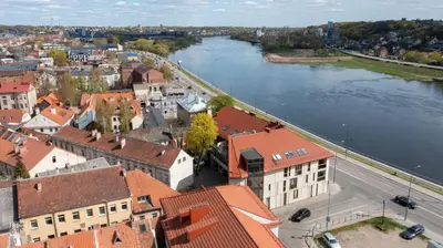 an aerial view of a city with a river and buildings at Kaunas Old Town apartment with underground parking in Kaunas