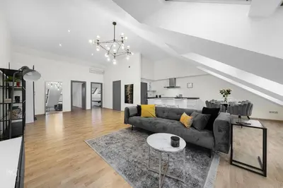 a living room with a couch and a table at Kaunas Old Town apartment with underground parking in Kaunas