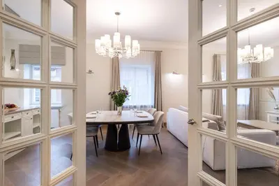 a dining room with a table and chairs and a room with a dining room at Luxury 2BDR Heart Of Old Town in Vilnius