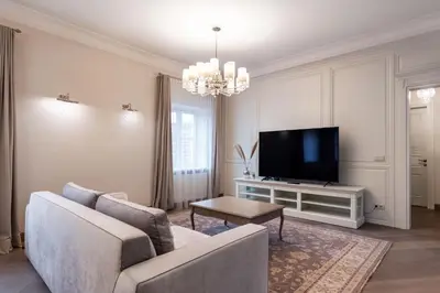 a living room with a couch and a tv at Luxury 2BDR Heart Of Old Town in Vilnius