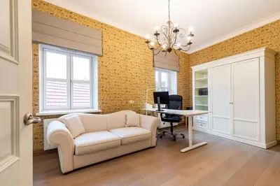 a living room with a white couch and a desk at Luxury 2BDR Heart Of Old Town in Vilnius