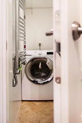 a washer and dryer sitting in a laundry room at Luxury 2BDR Heart Of Old Town in Vilnius