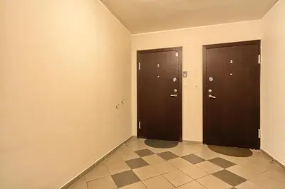 two brown doors in a room with a tile floor at Cozy Center Druskininkai in Druskininkai