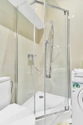 a shower stall in a bathroom with a toilet at New and Lovely Apartament in Vilnius City Centre in Vilnius