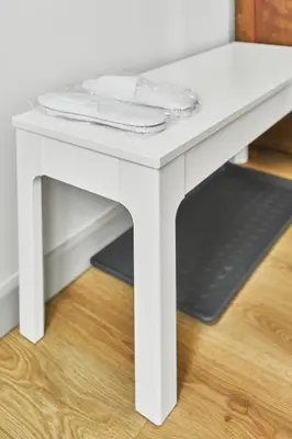 a white table sitting on top of a wooden floor at New and Lovely Apartament in Vilnius City Centre in Vilnius