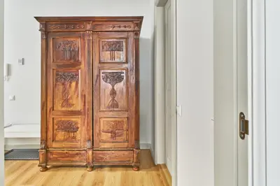 a wooden cabinet in a room with a door at New and Lovely Apartament in Vilnius City Centre in Vilnius