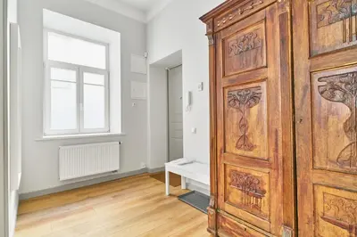 a large wooden door in a room with a window at New and Lovely Apartament in Vilnius City Centre in Vilnius