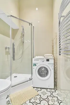 a bathroom with a washing machine and a shower at New and Lovely Apartament in Vilnius City Centre in Vilnius