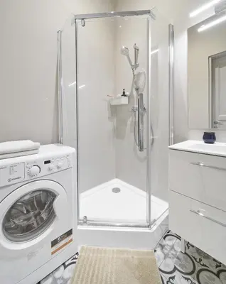 a bathroom with a washing machine and a shower at Bright and Warm Apartment, Vilnius City Centre in Vilnius