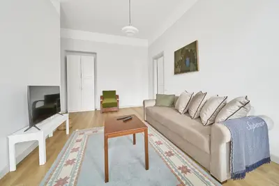 a living room with a couch and a table at Bright and Warm Apartment, Vilnius City Centre in Vilnius