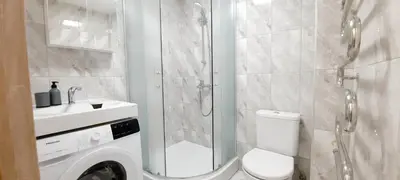 a bathroom with a shower and a toilet and a sink at M&M Apartment II SELF CHECK-IN in Panevėžys