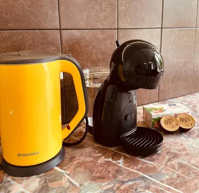a yellow and black toaster sitting on a counter at M&M Apartment II SELF CHECK-IN in Panevėžys