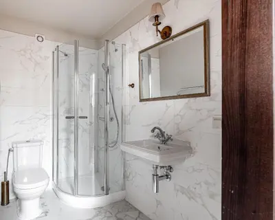 a bathroom with a shower and a sink and a toilet at Luxury Gaono in Old Town in Vilnius