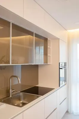 a kitchen with white cabinets and a sink at Luxurious Blue&Yellow Apartment in Kaunas Center in Kaunas