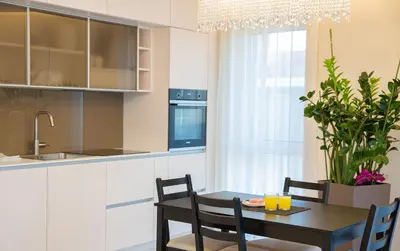 a kitchen and dining room with a table and chairs at Luxurious Blue&Yellow Apartment in Kaunas Center in Kaunas