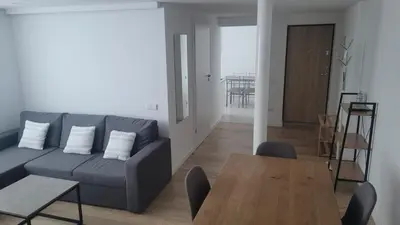 a living room with a couch and a table at City center apartment in Alytus