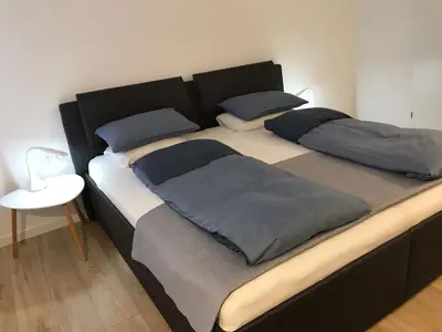 a large bed with two pillows on top of it at City center apartment in Alytus