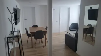 a dining room with a table and chairs at City center apartment in Alytus