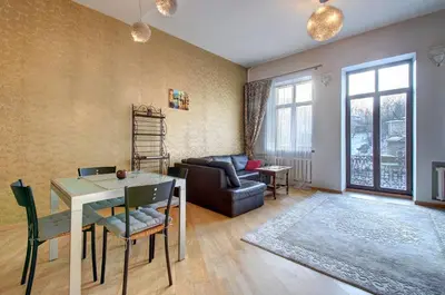 a living room with a table and a couch at Romantic City Center Apartment in Old Town in Vilnius