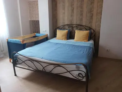 a bedroom with a bed with blue sheets and yellow pillows at Romantic City Center Apartment in Old Town in Vilnius
