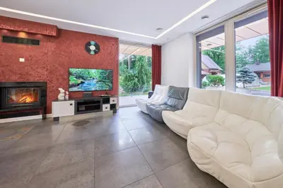 a living room with a white couch and a fireplace at Luxury villas Kaunas in Šlienava