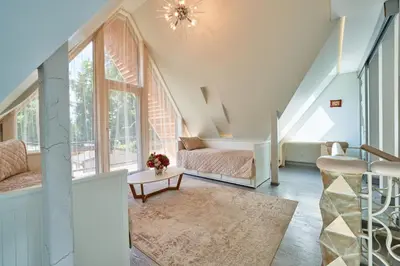 a living room with a bed and a window at Luxury villas Kaunas in Šlienava
