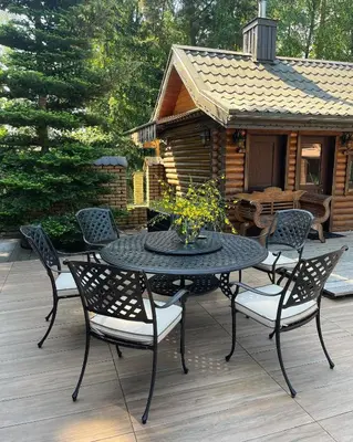 a patio with a table and chairs and a cabin at Luxury villas Kaunas in Šlienava