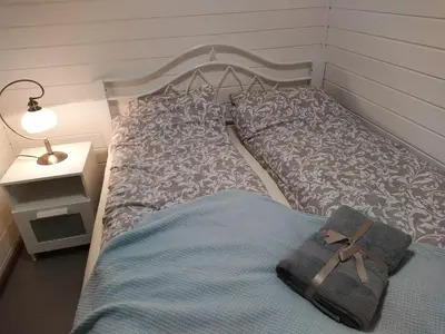 a bedroom with a bed with a bag on it at Riešutynė in Gražuliai