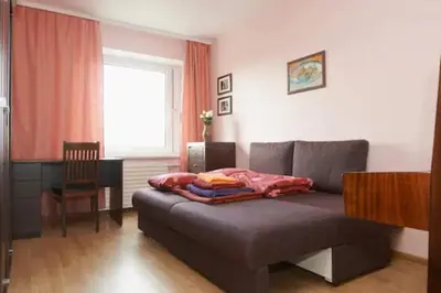a living room with a couch and a table and a window at Nice private room in a three room apartment Free parking Feel like at home in Vilnius