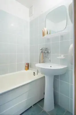 a white bathroom with a sink and a bath tub at Nice private room in a three room apartment Free parking Feel like at home in Vilnius