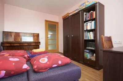 a living room with two pillows on a couch at Nice private room in a three room apartment Free parking Feel like at home in Vilnius