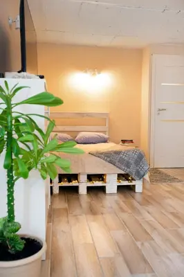 a bedroom with a bed and a potted plant at Apartment in Garage with free parking in Kaunas