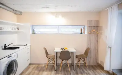 a small kitchen with a table and chairs at Apartment in Garage with free parking in Kaunas