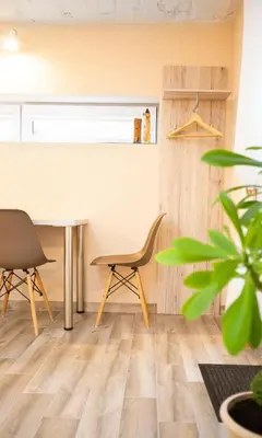 an office with a table and chairs and a plant at Apartment in Garage with free parking in Kaunas