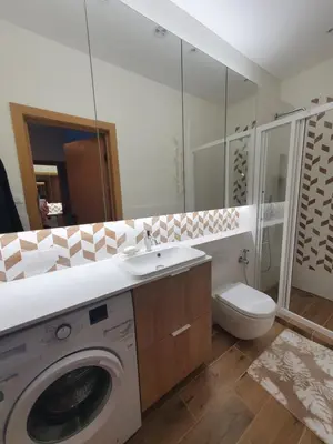 a bathroom with a washing machine and a toilet at Žvėrynas Workation apartments in Vilnius