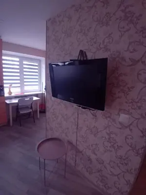 a living room with a flat screen tv on a wall at Butas miesto centre - bulvare in Šiauliai