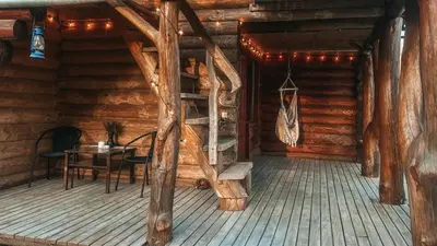 a room with a table and chairs in a log cabin at Laukupės sodyba in Rokiškis