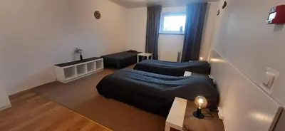 a small room with two beds and a window at Elite Flats Two bedroom in Utena