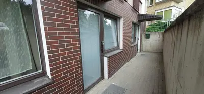 an empty alley with a brick building and a window at Elite Flats Two bedroom in Utena