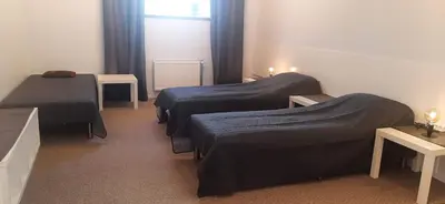 a room with two beds and a window at Elite Flats Two bedroom in Utena