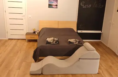 a bedroom with a bed and a chalkboard on the wall at Elite Flats Two bedroom in Utena