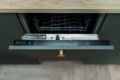 an oven with a book sitting on top of it at Cozy Piliamiesčio apartament No 1 by URBAN RENT in Kaunas