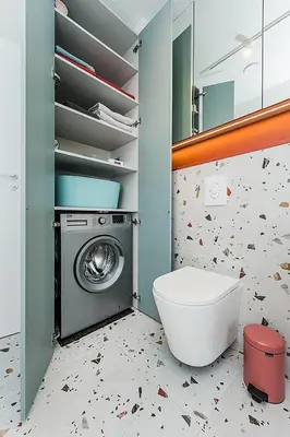 a bathroom with a washing machine and a toilet at Cozy Piliamiesčio apartament No 1 by URBAN RENT in Kaunas