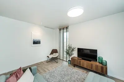 a living room with a tv and a couch at Cozy Piliamiesčio apartament No 1 by URBAN RENT in Kaunas