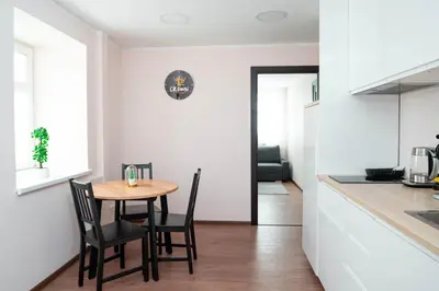 a kitchen and dining room with a table and chairs at Crown Apartment in Ukmergė