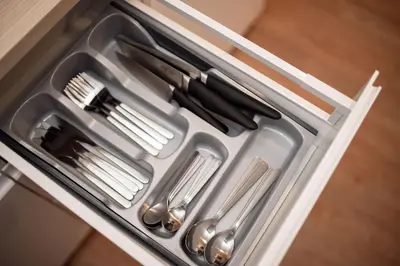 a drawer filled with utensils in a refrigerator at Crown Apartment in Ukmergė