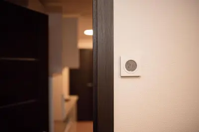 an open door with a light switch on it at Crown Apartment in Ukmergė