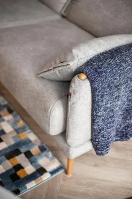 a couch with a pillow on top of it at #stayhere Modern & Compact 1BDR Uptown Vilnius in Vilnius