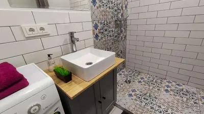 a white bathroom with a sink and a shower at K-Town - Apartments ViaBaltic Kaunas in Kaunas